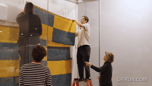 Still from Installing the Wari Feather Panel at The Met Still from Installing the Wari Feather Panel at The Met